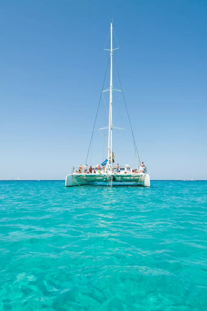 The SunCat catamaran at anchor on clear turquoise water