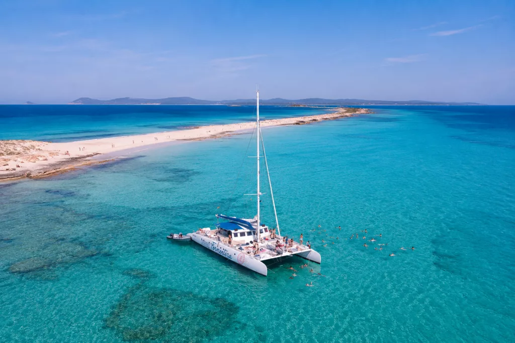 Ses Illetes sandbank in Formentera with the catamaran at anchor