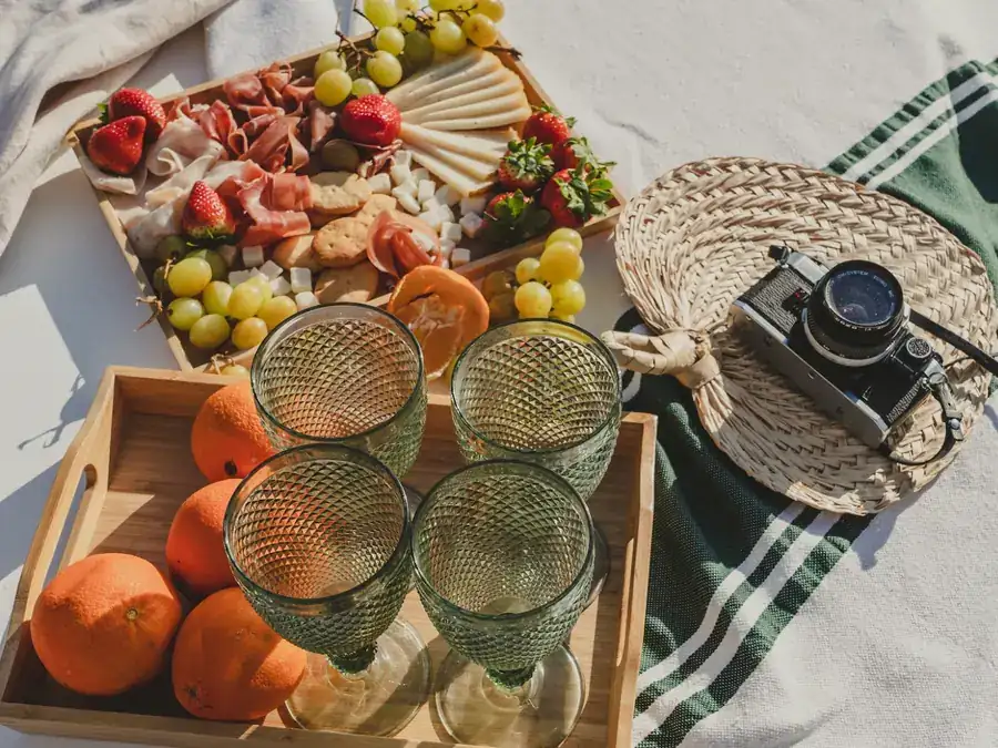 Catering board with cheese, cured ham, fruit and glasses prepared for a boat event in Mallorca