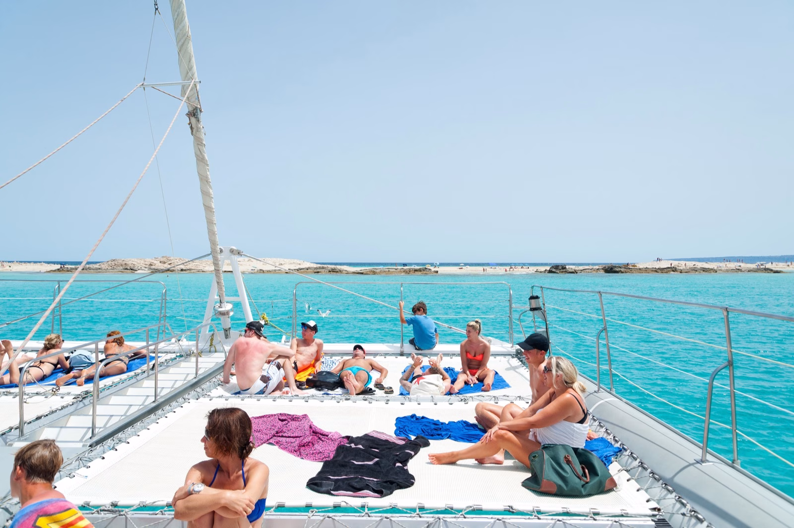 Guests relaxing on the bow nets of the SunCat